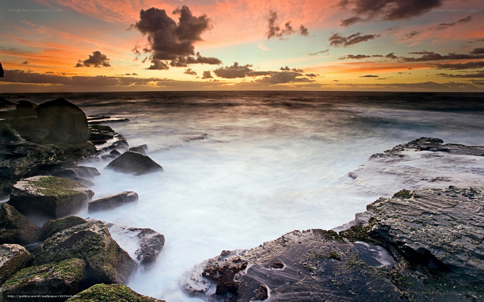 Sunset over rocky coastline