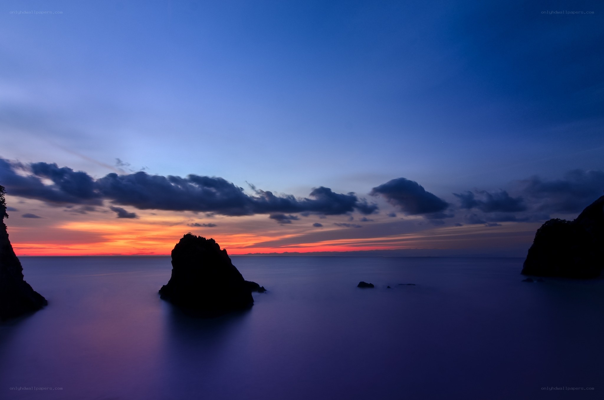 Sunset over rocky coastline