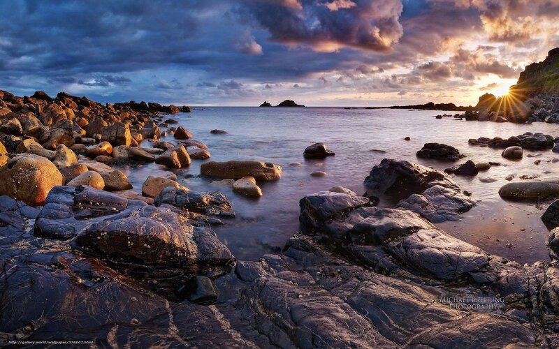 Sunset over rocky coastline