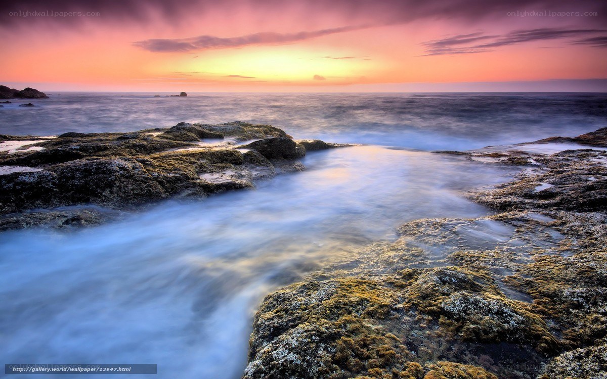 Sunset over rocky coastline