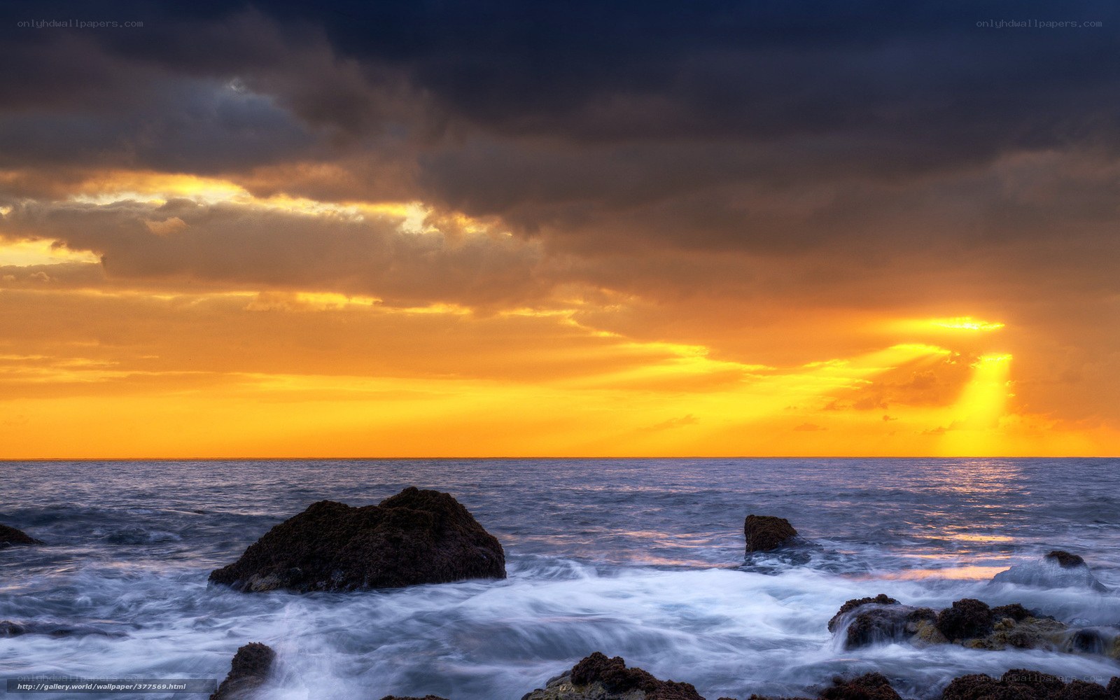 Sunset over rocky coastline