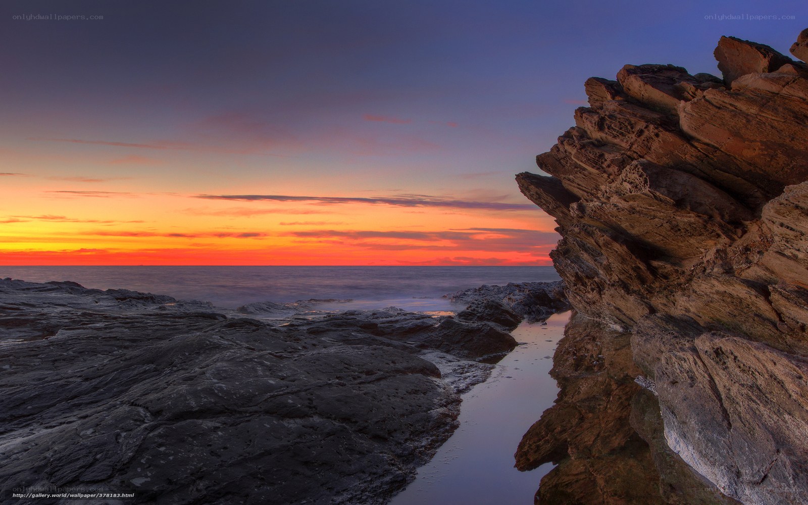 Sunset over rocky coastline