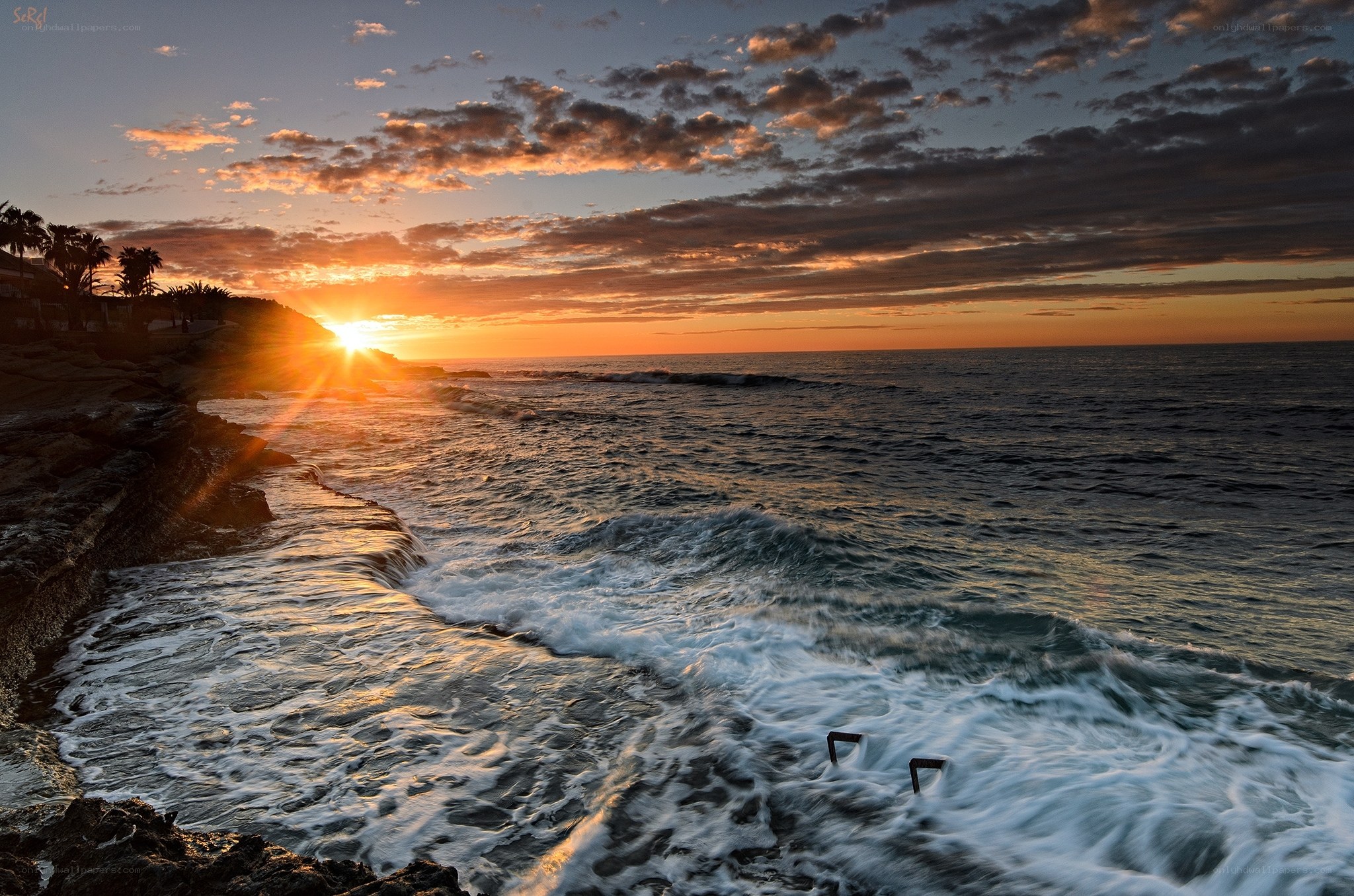 Sunset over rocky coastline