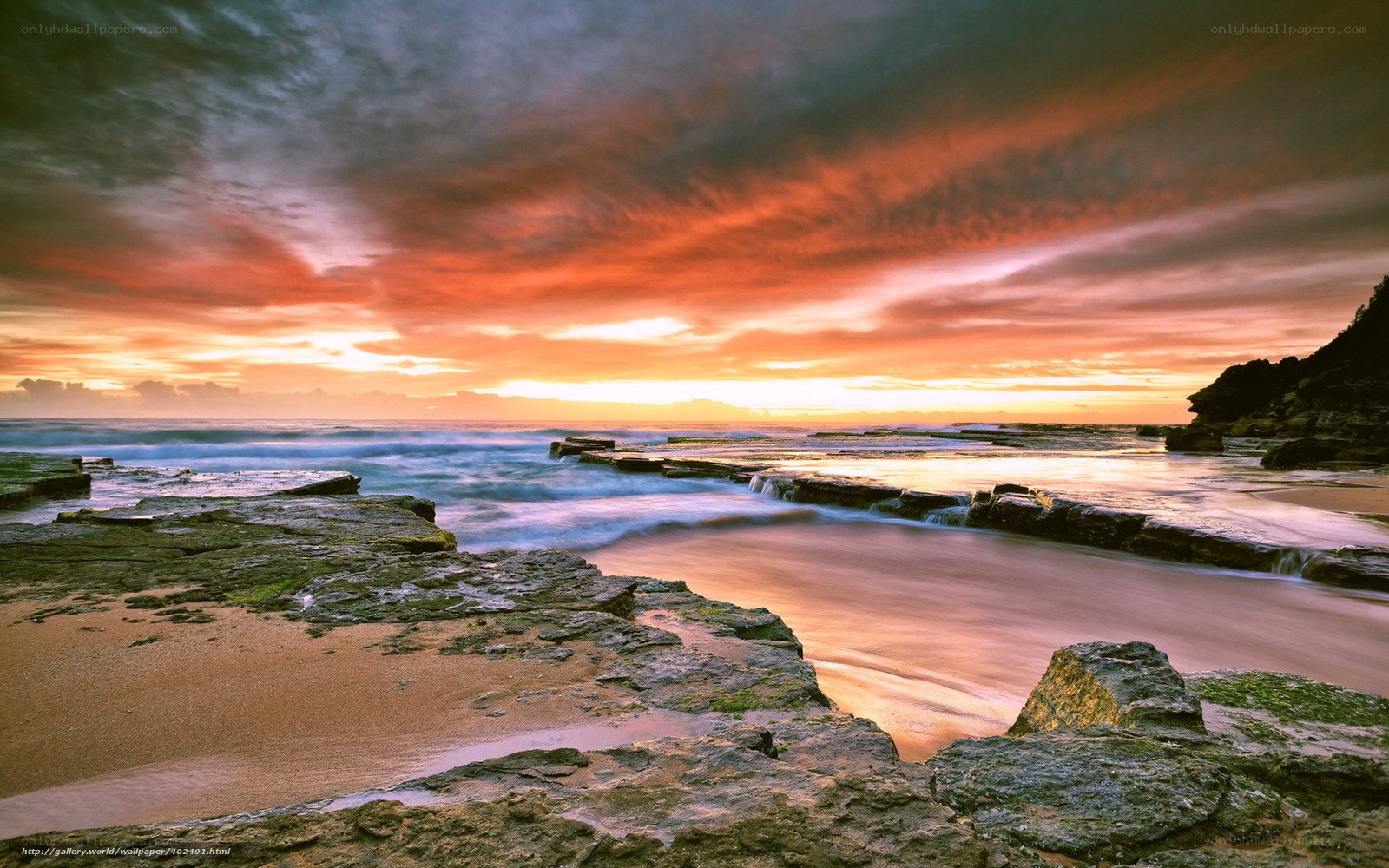 Sunset over rocky coastline