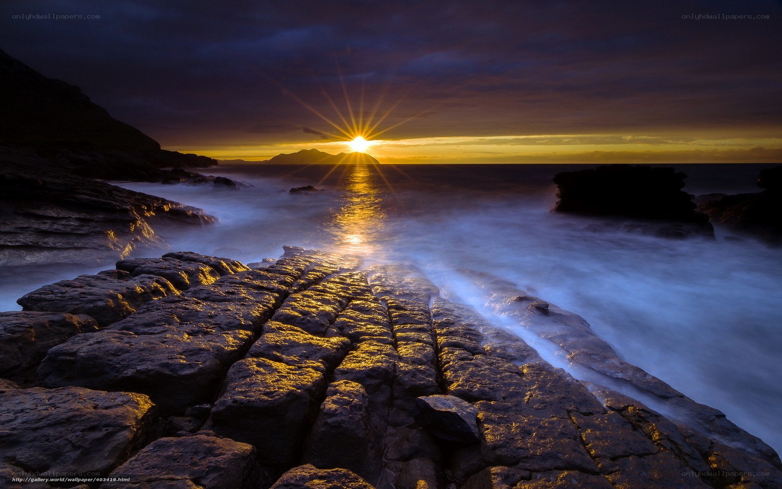Sunset over rocky coastline