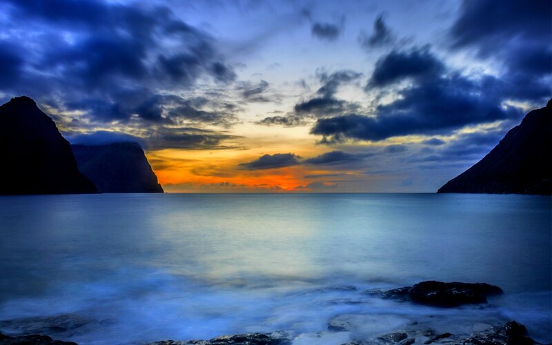 Sunset over Rocky Coastline — Blue