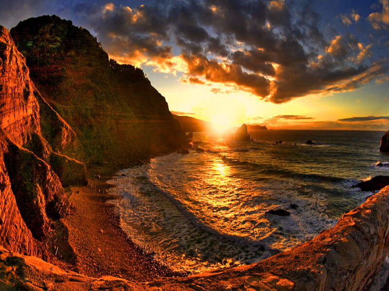 Sunset over Rocky Coastline — Orange, Dramatic