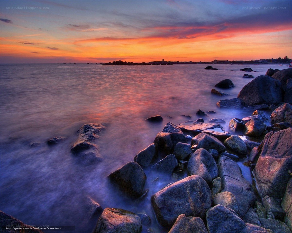 sunset over rocky coastline