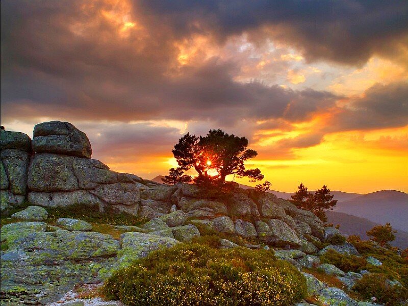 Sunset over rocky hill
