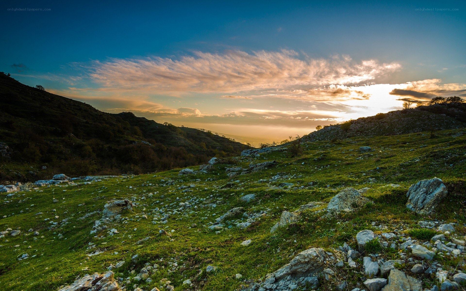 Sunset over rocky hills