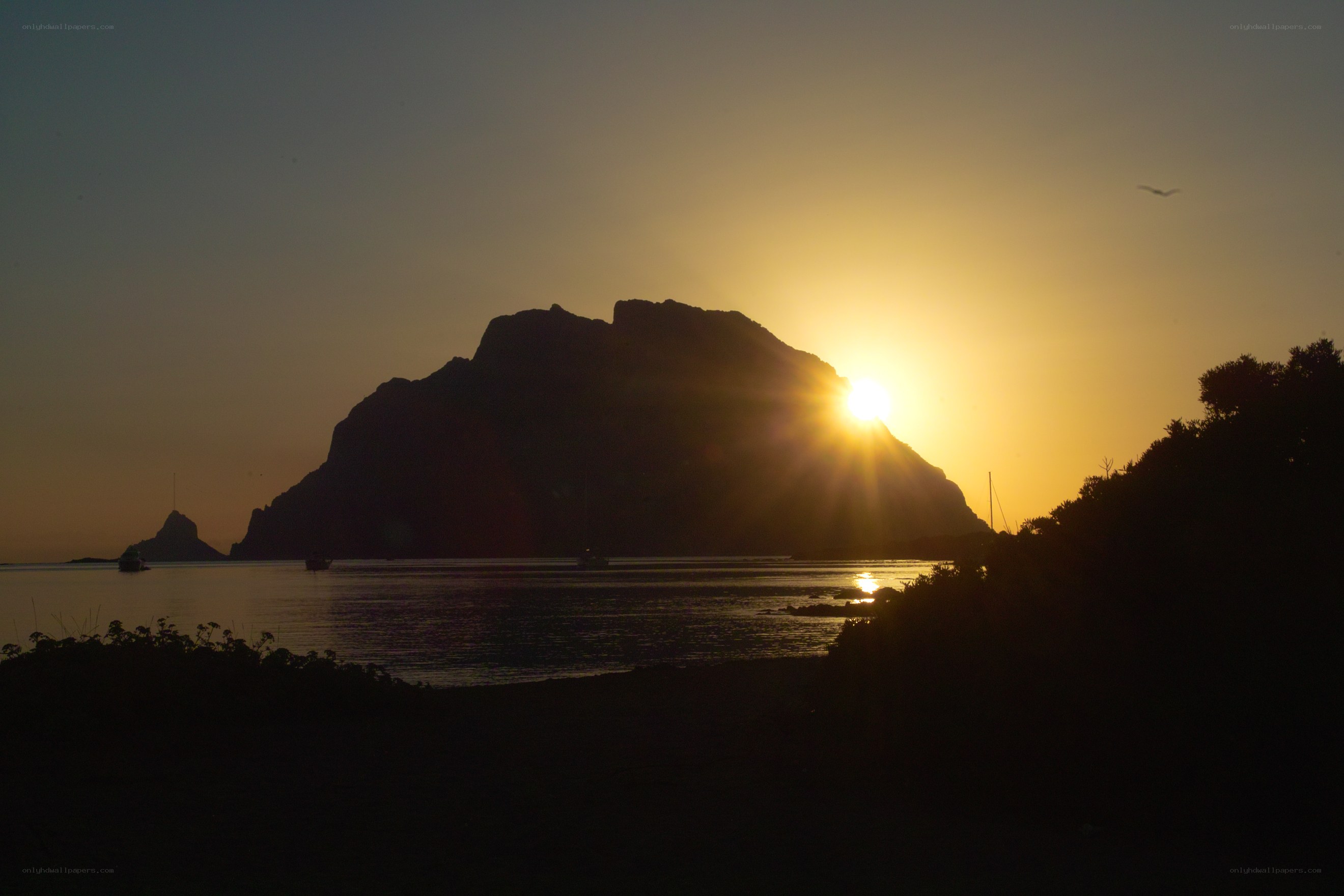 Sunset over rocky island