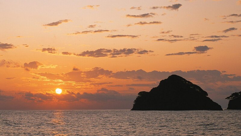 sunset over rocky island