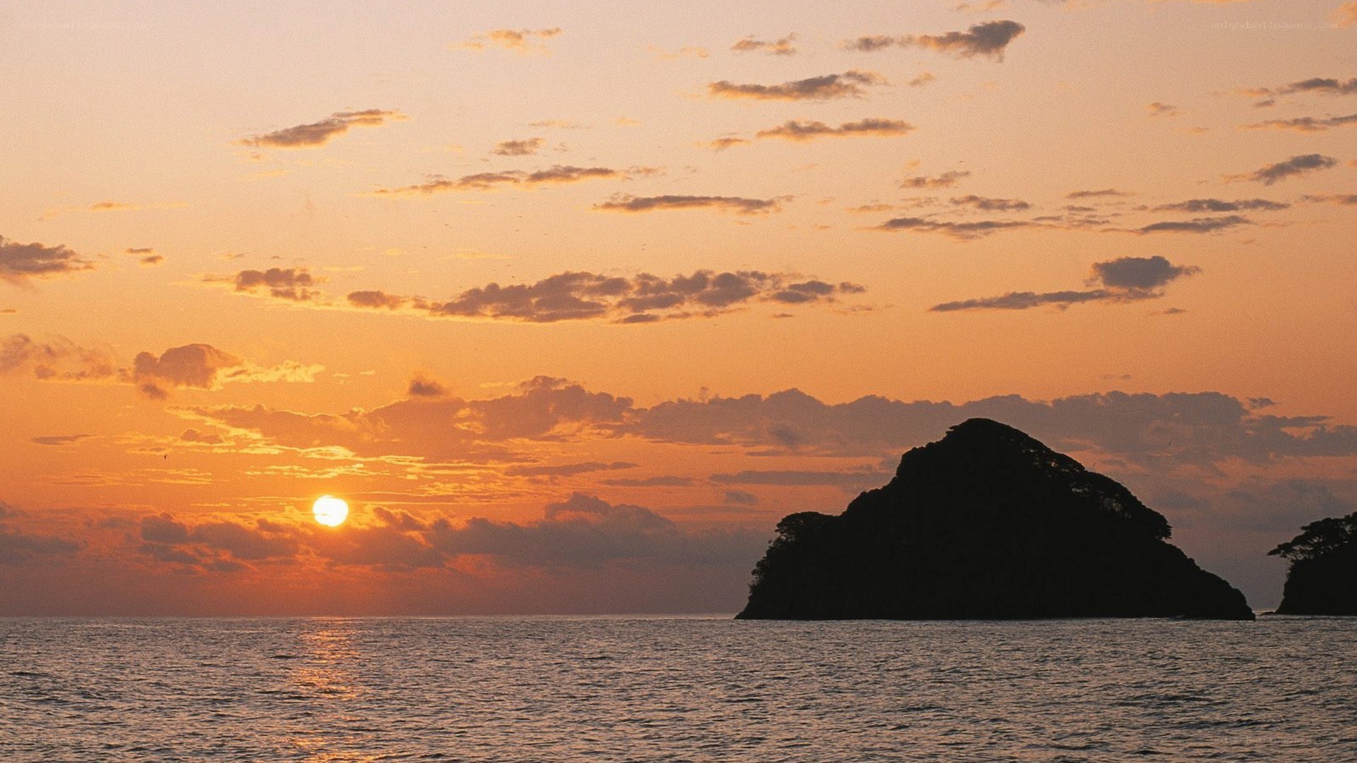 sunset over rocky island
