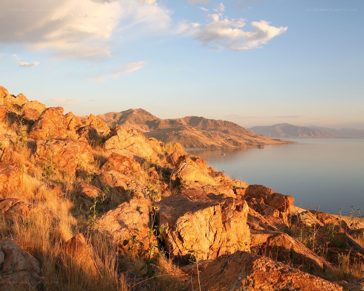 Sunset over rocky lake shore