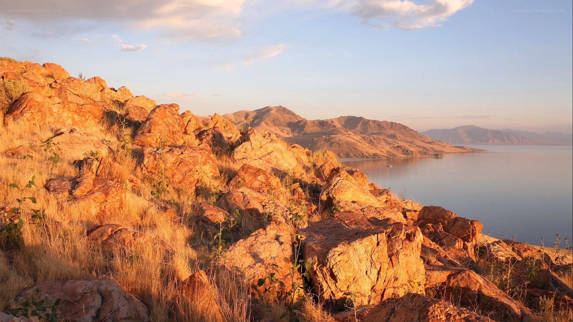 Sunset over rocky lake shore