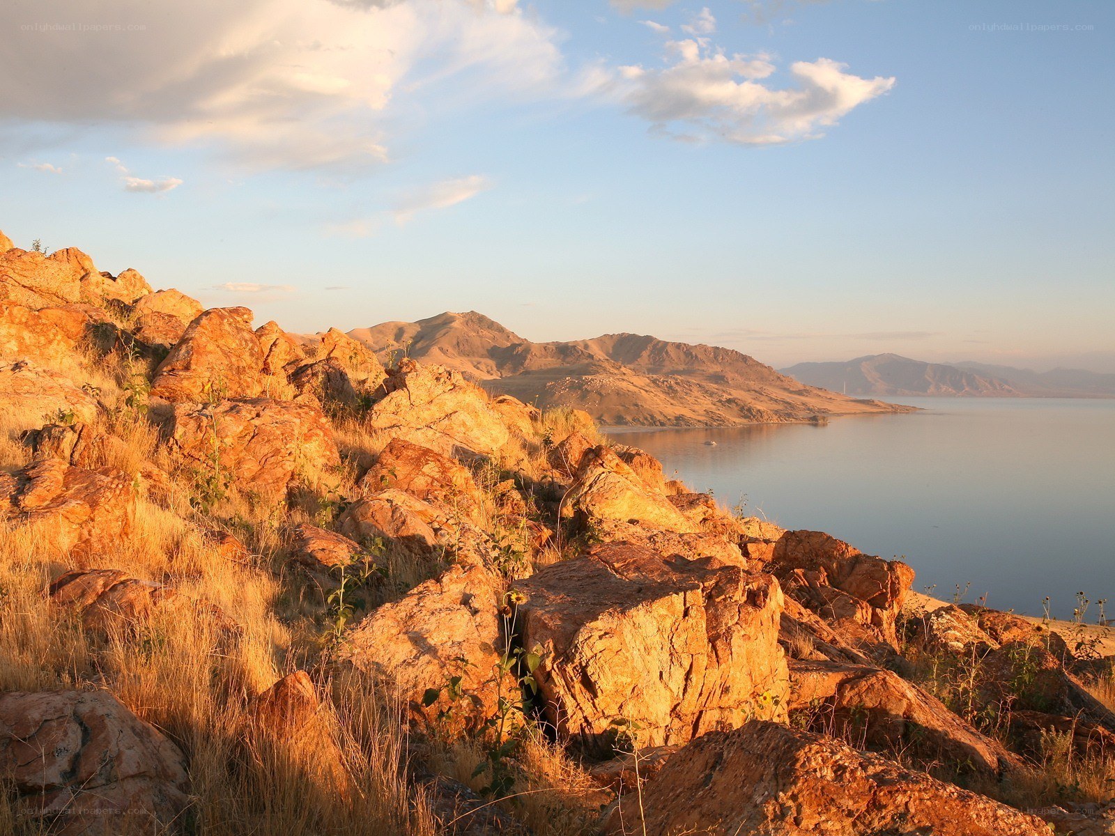 Sunset over rocky lake shore