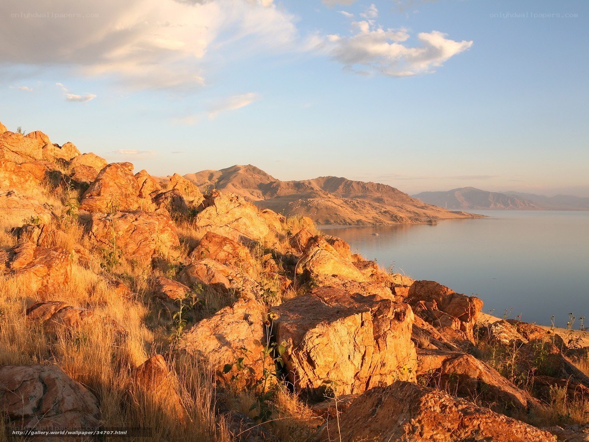 Sunset over rocky lake shore