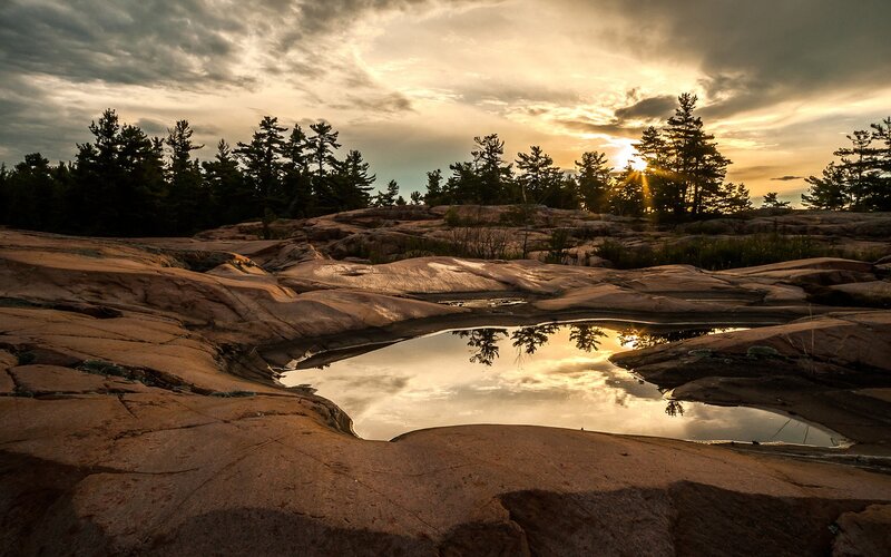Sunset over rocky pond