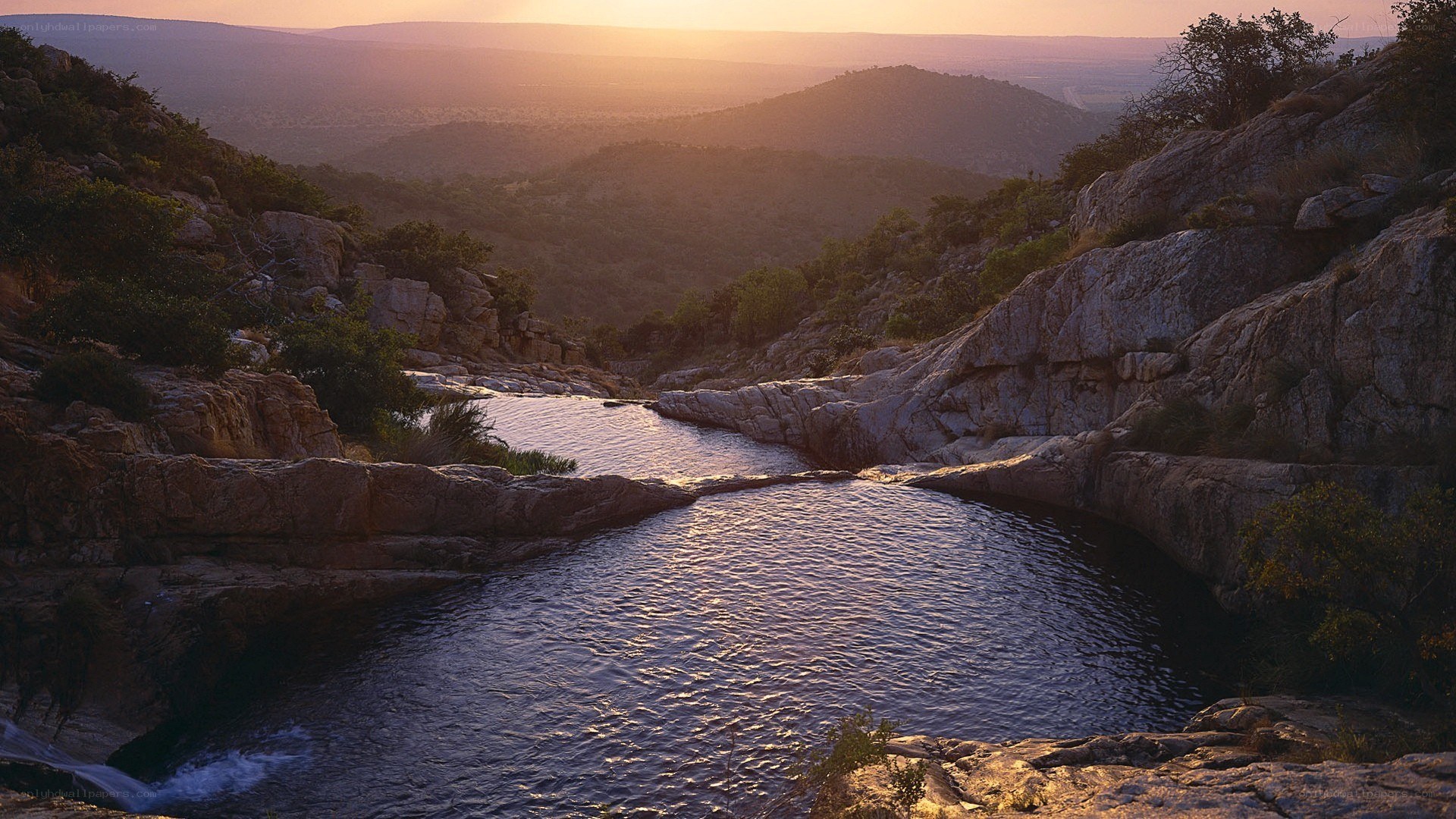 Sunset over rocky river canyon