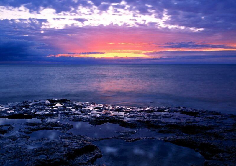 sunset over rocky shore