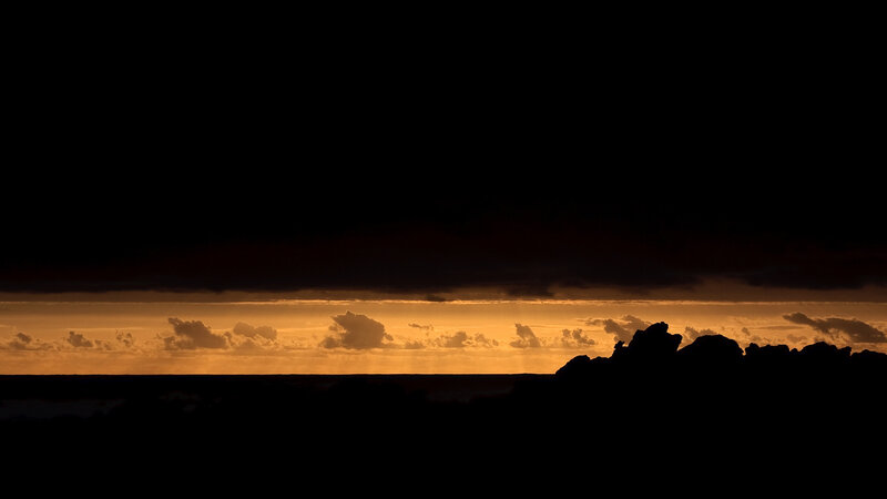 sunset over rocky shore