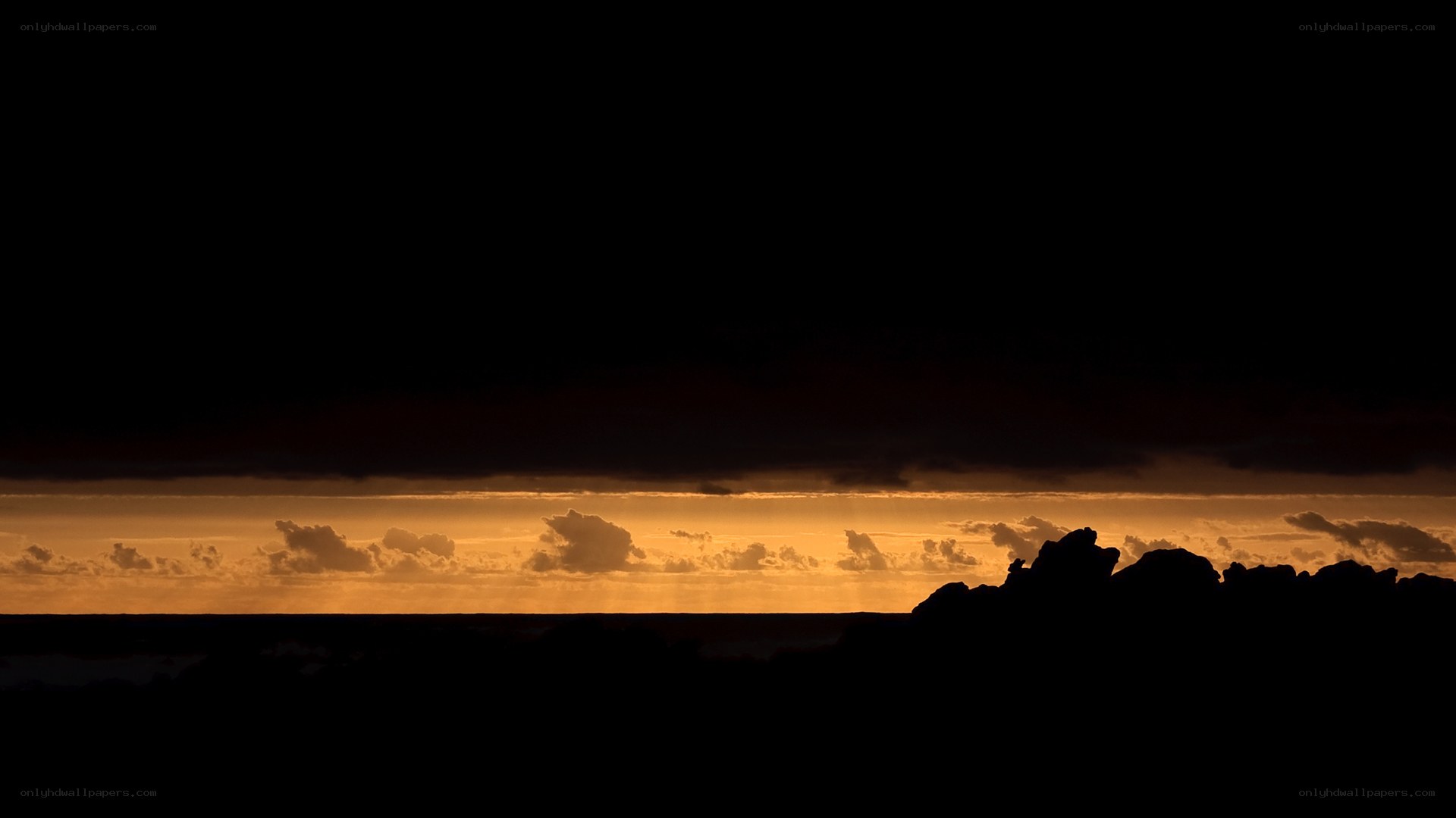 sunset over rocky shore
