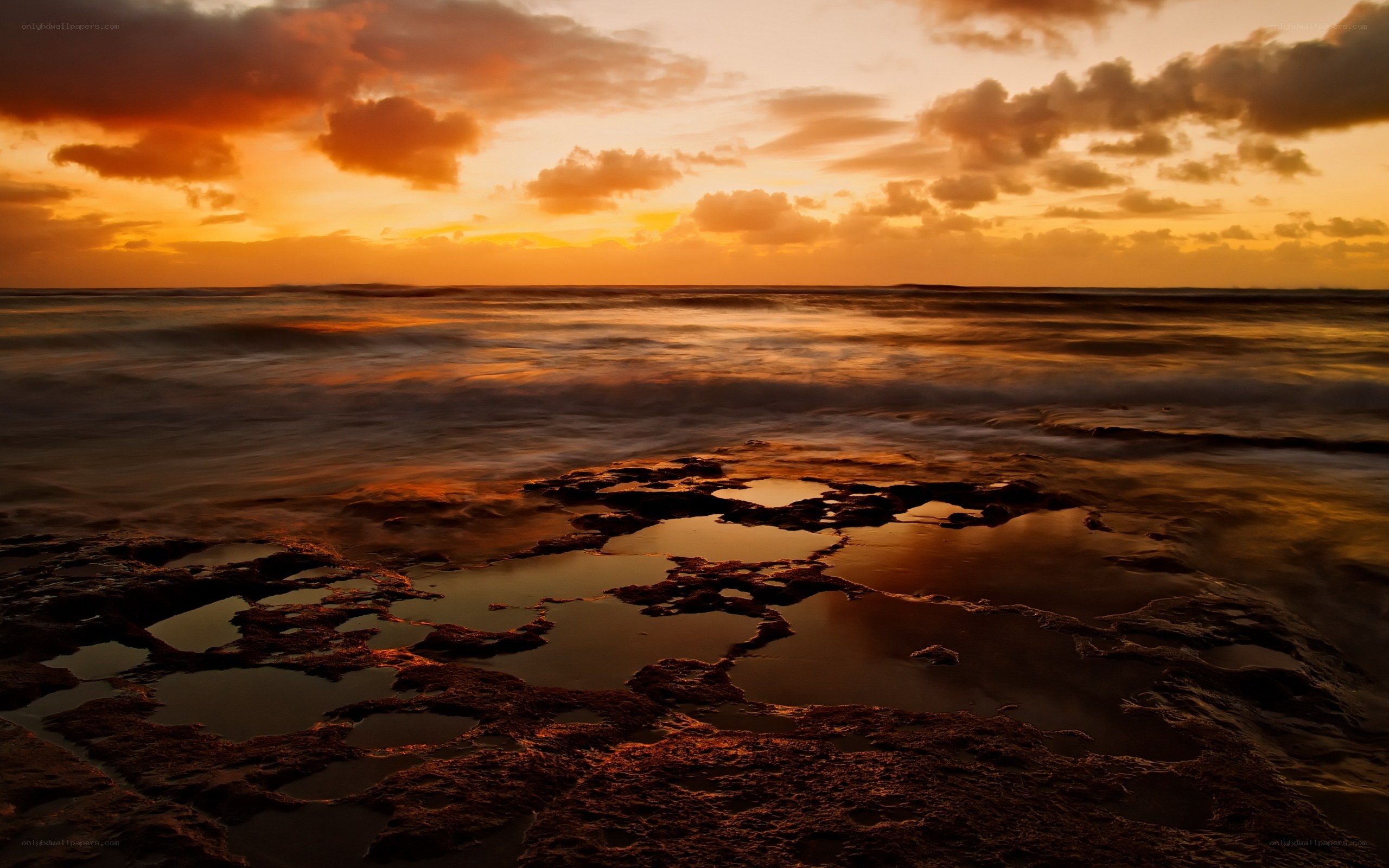 Sunset over rocky shore