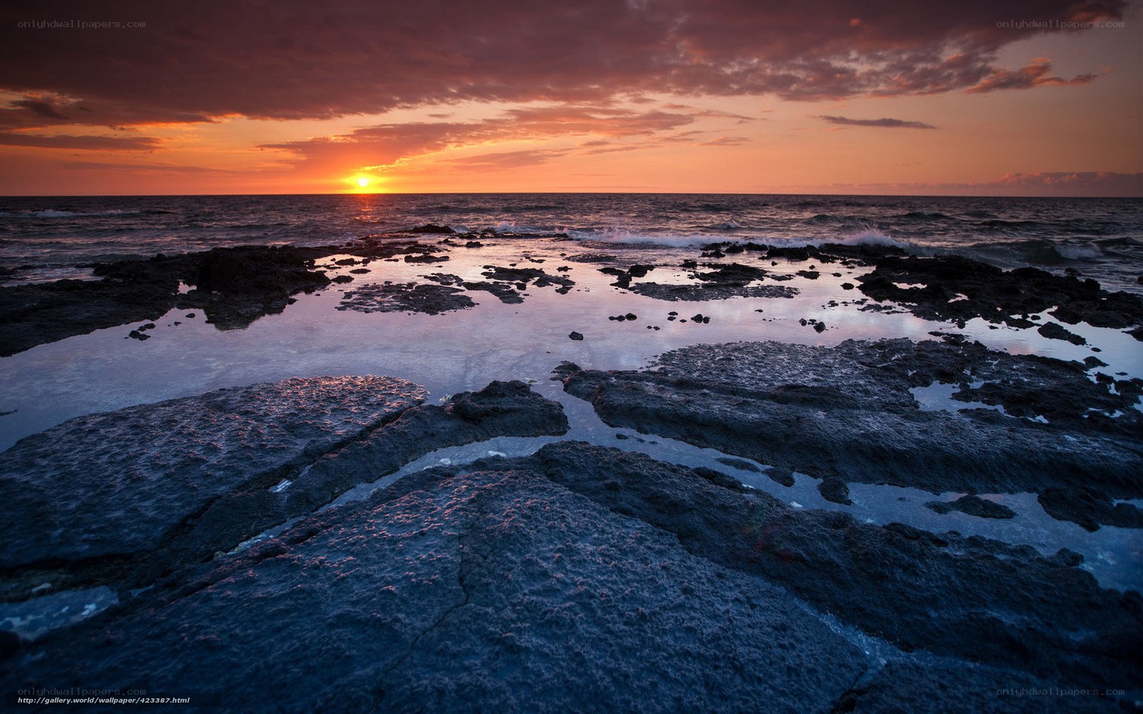 sunset over rocky shore