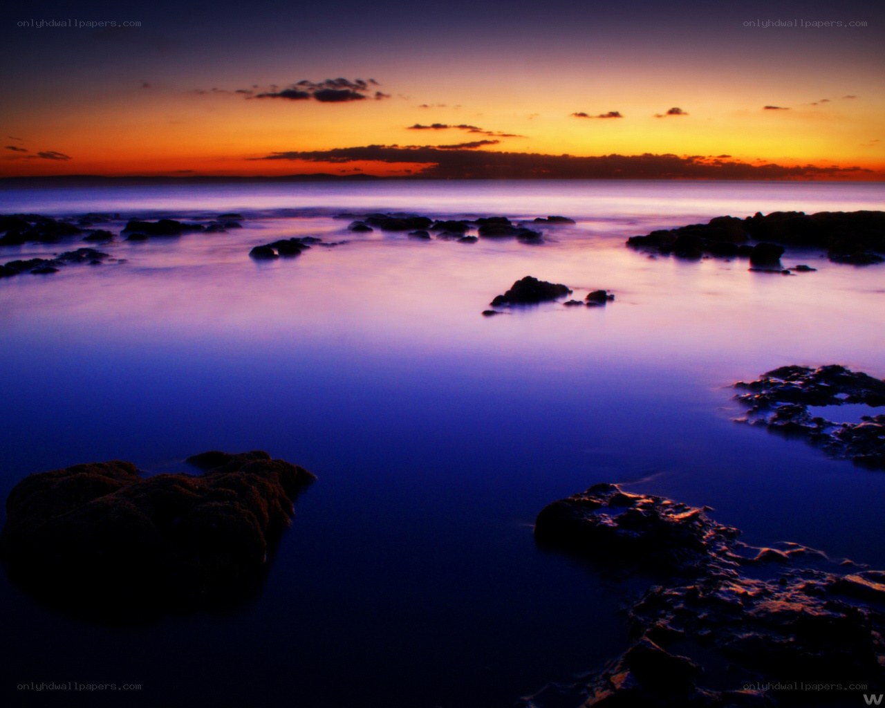 Sunset over rocky shore