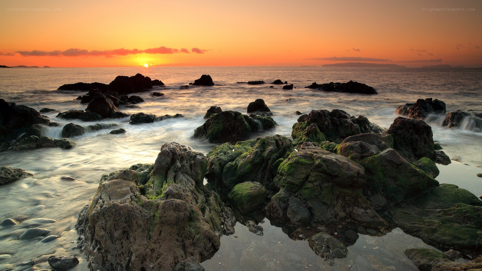 Sunset over rocky shore
