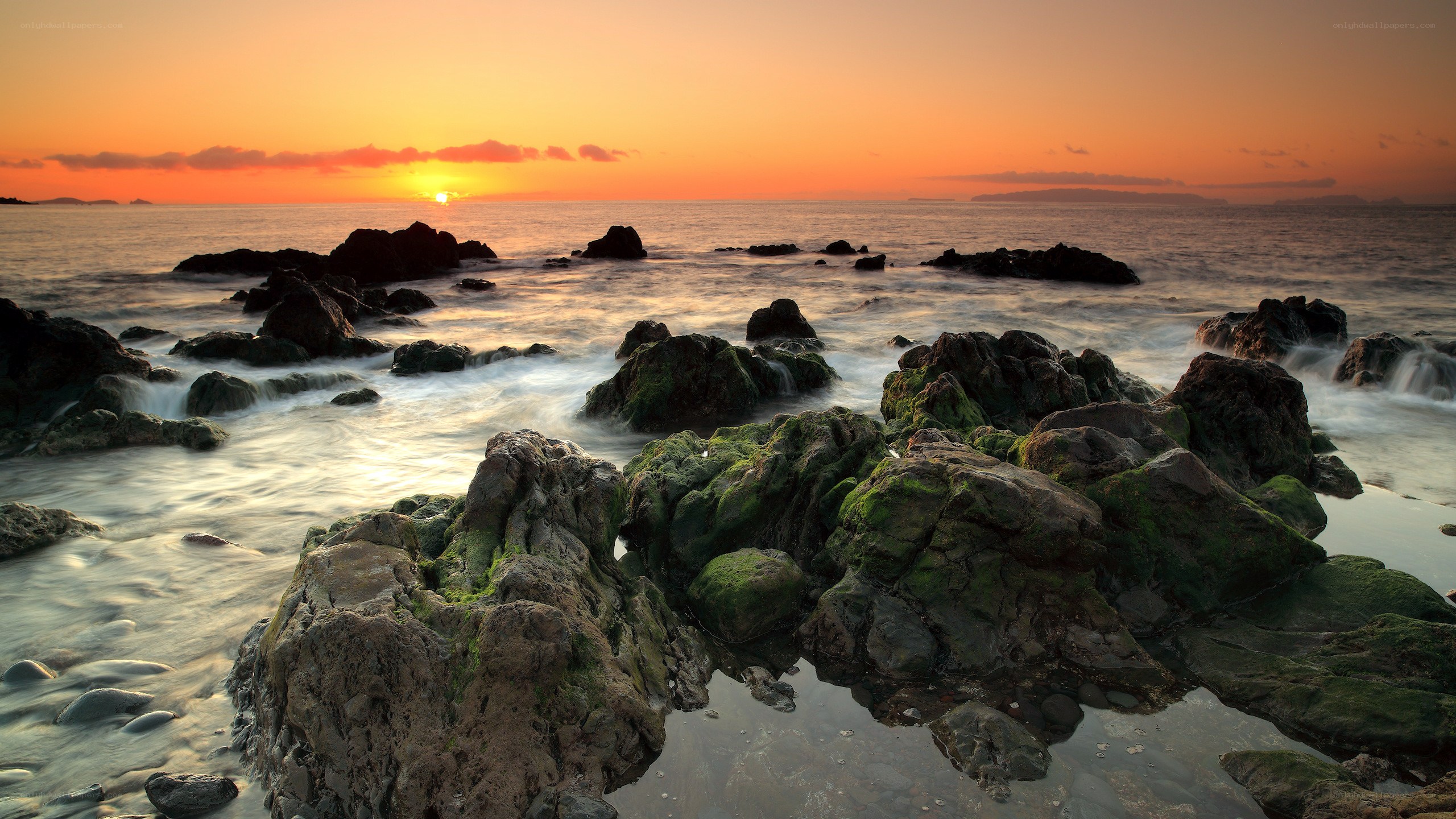 Sunset over rocky shore