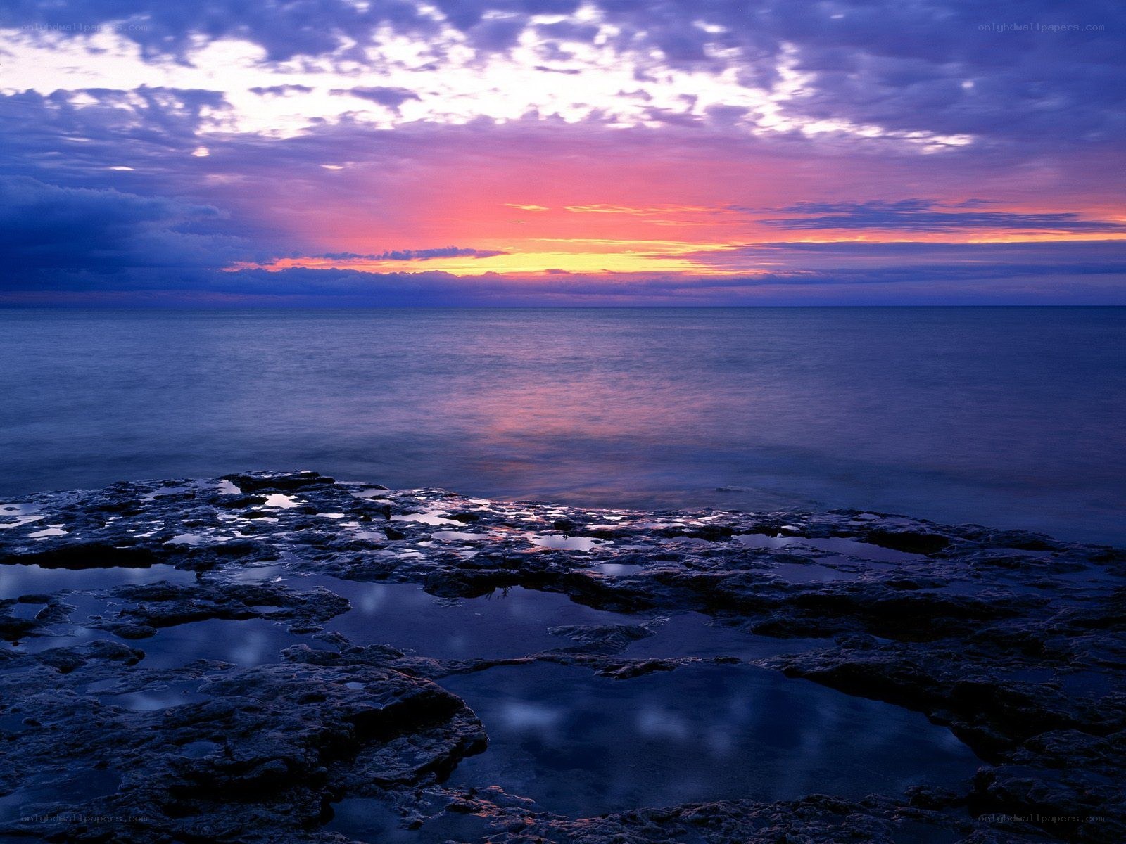 Sunset over rocky shore