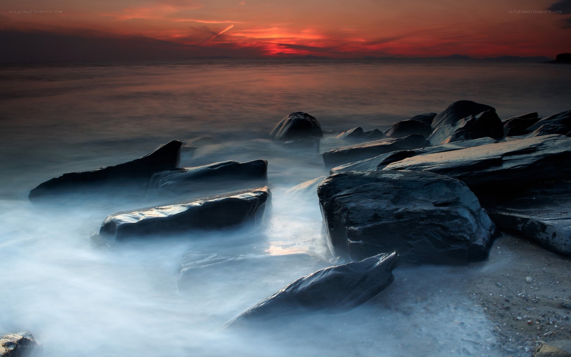Sunset over rocky shore