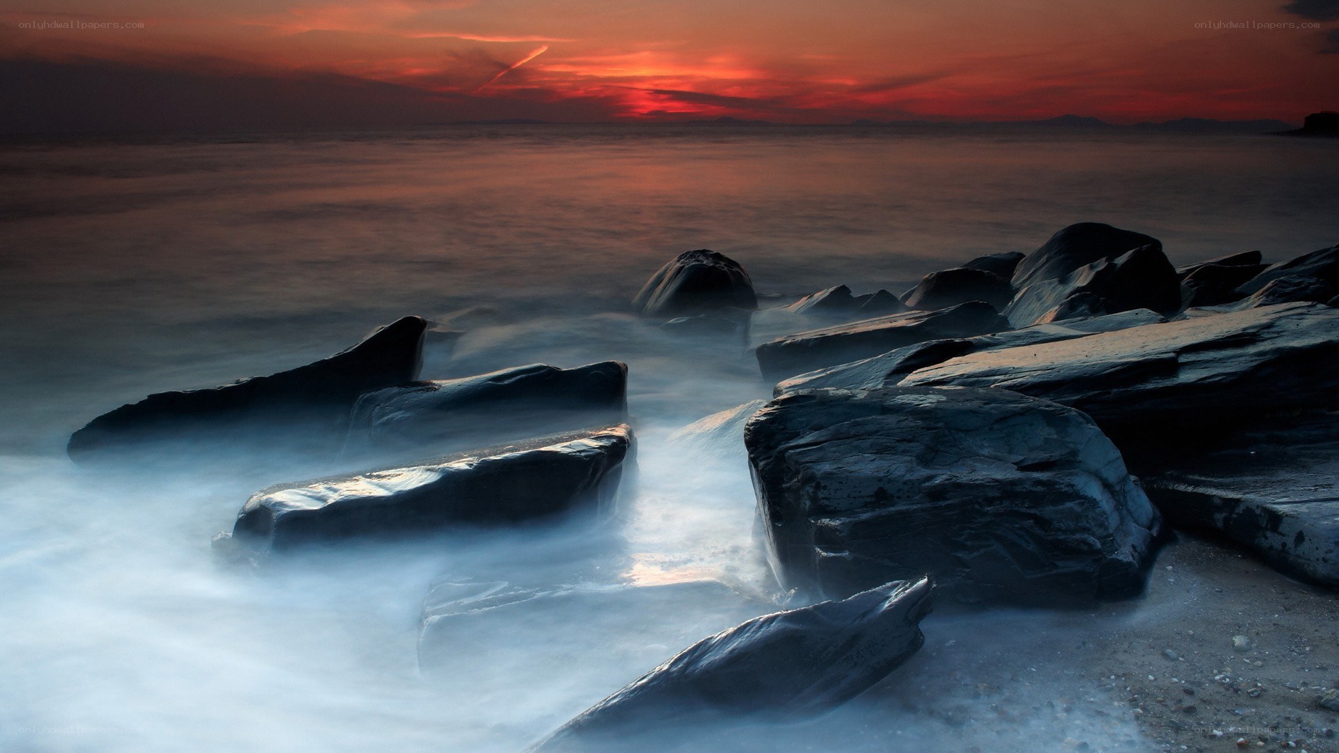 Sunset over rocky shore
