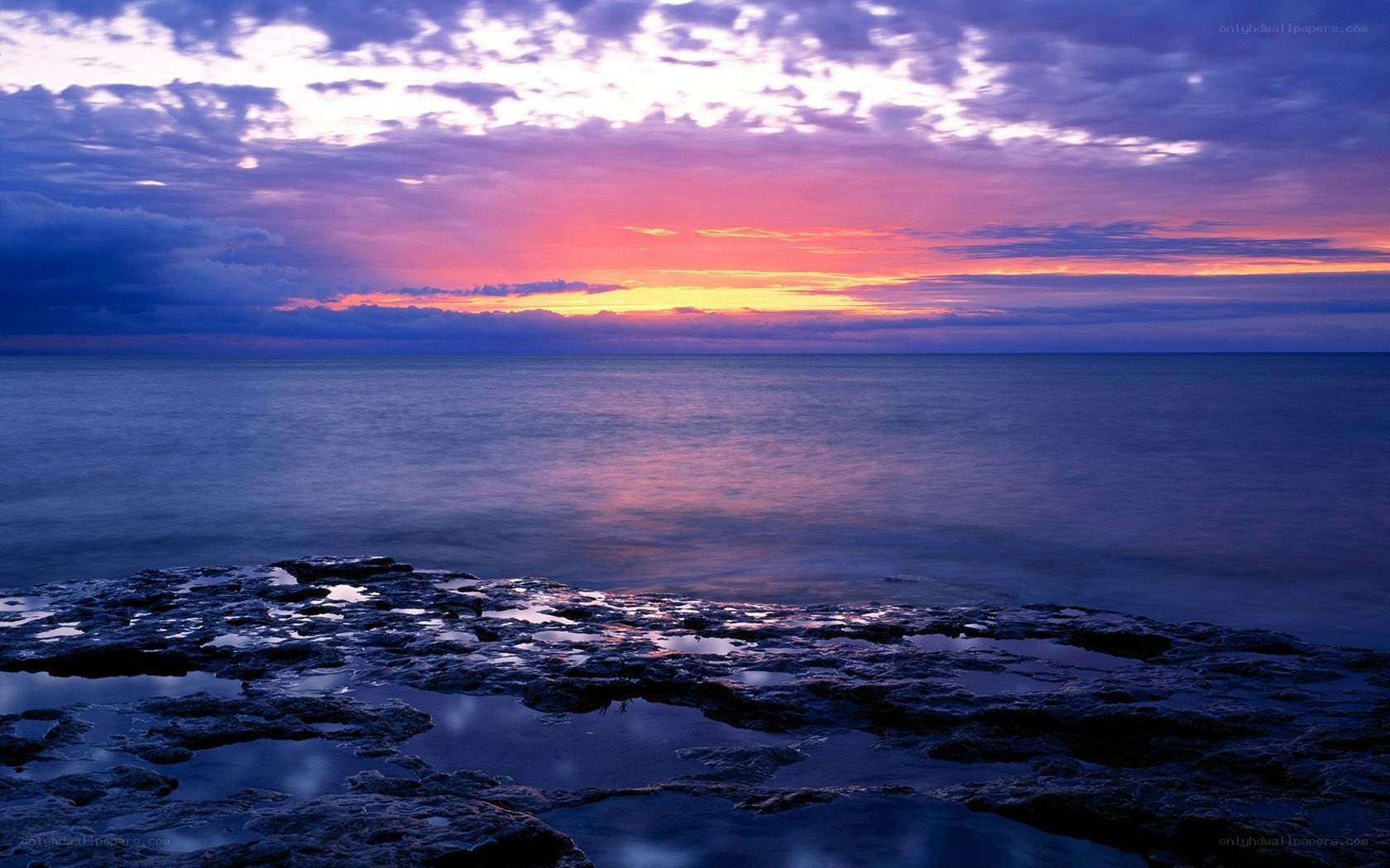 Sunset over rocky shore