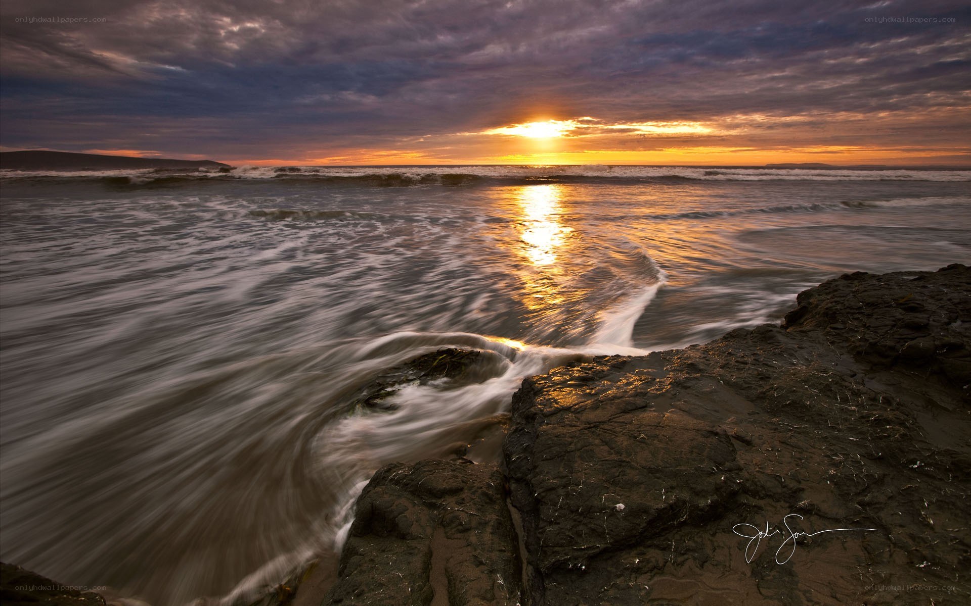 Sunset over rocky shore