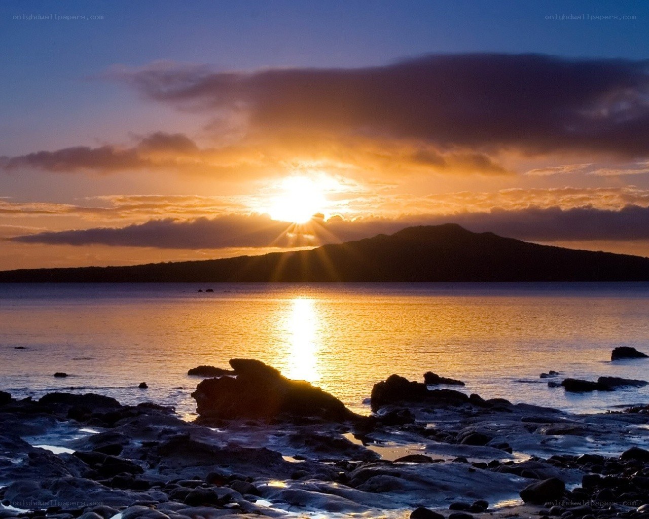 Sunset over rocky shore
