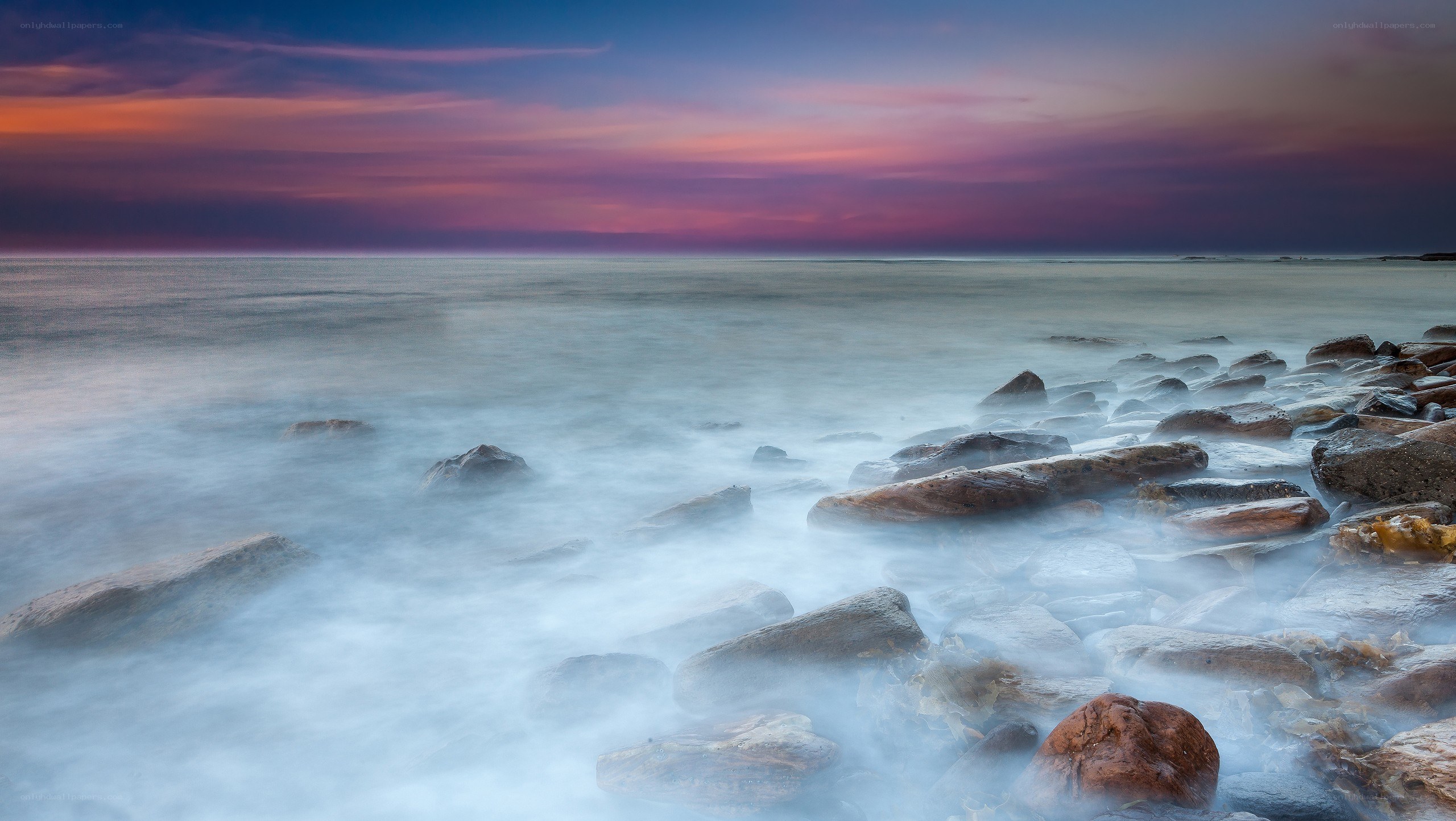 Sunset over rocky shore