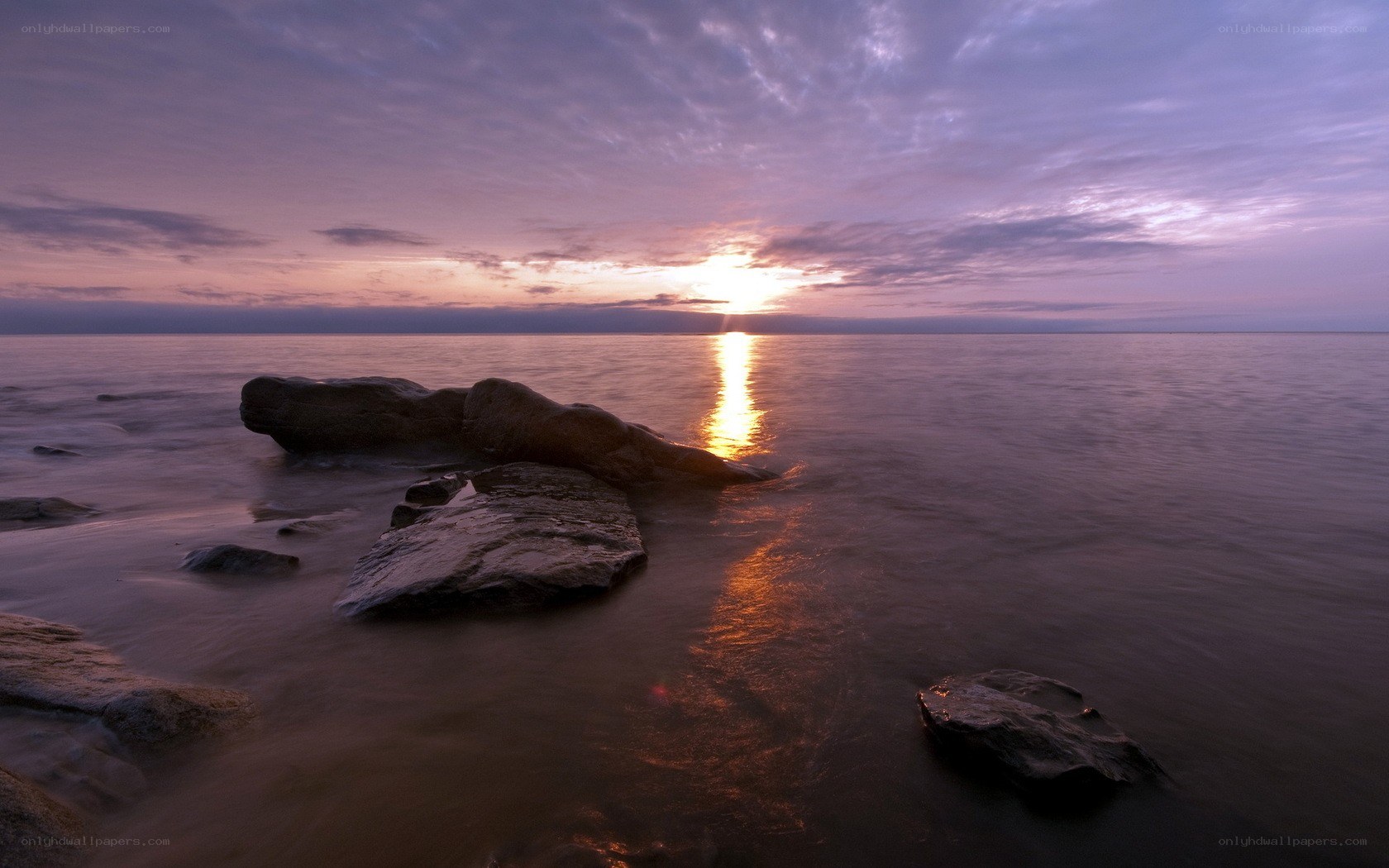 Sunset over rocky shore
