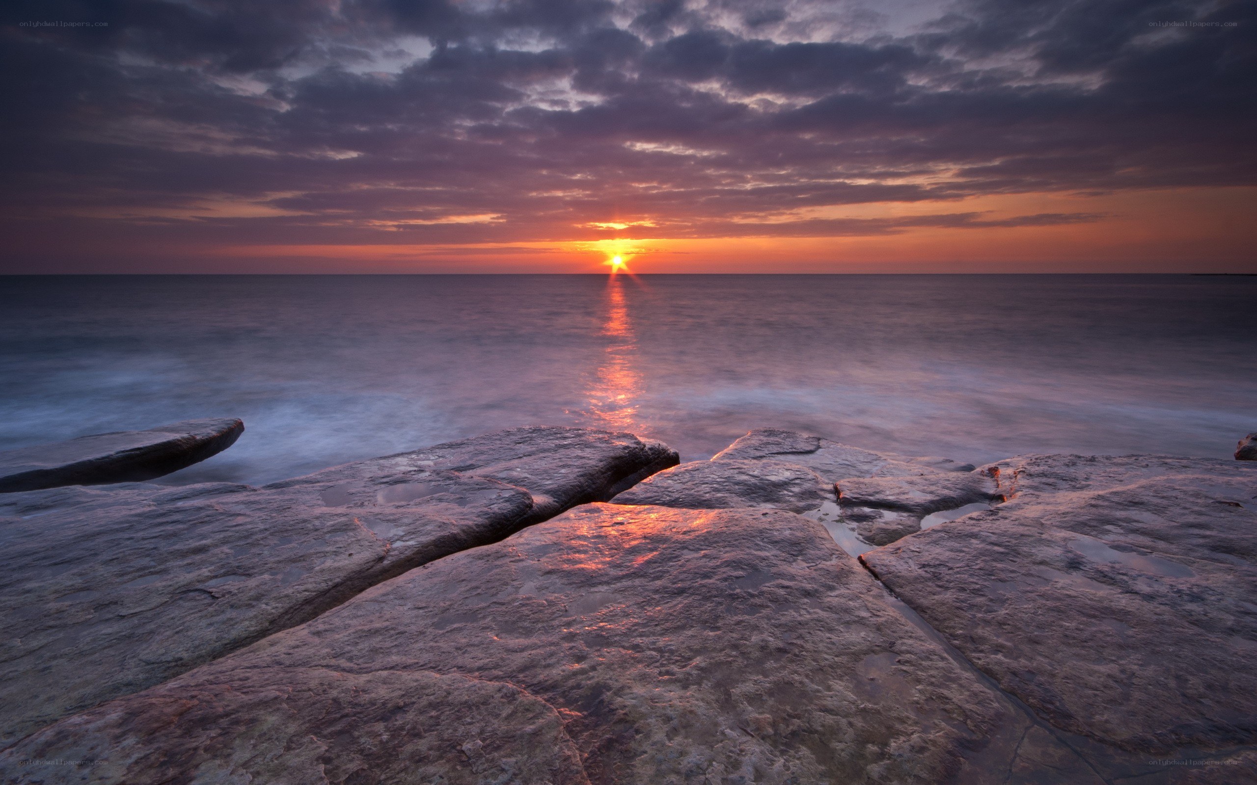 Sunset over rocky shore