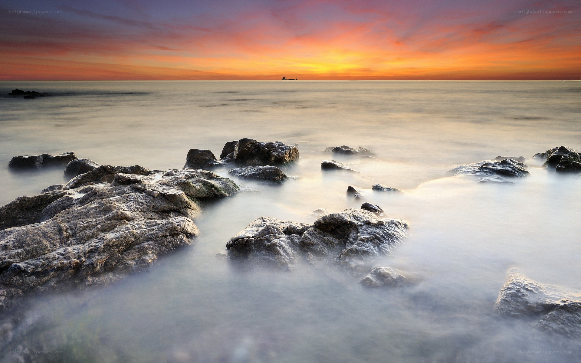 Sunset over rocky shore