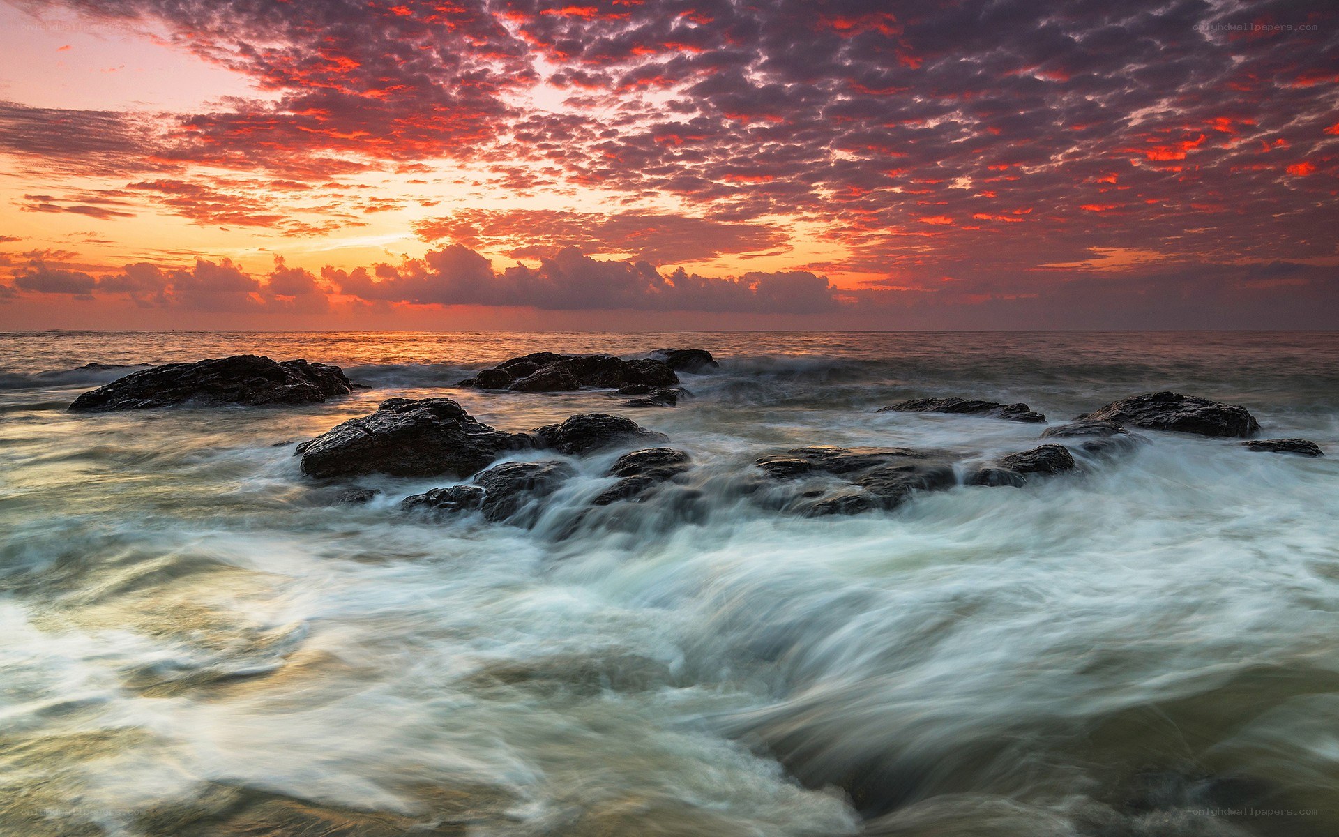 Sunset over rocky shore