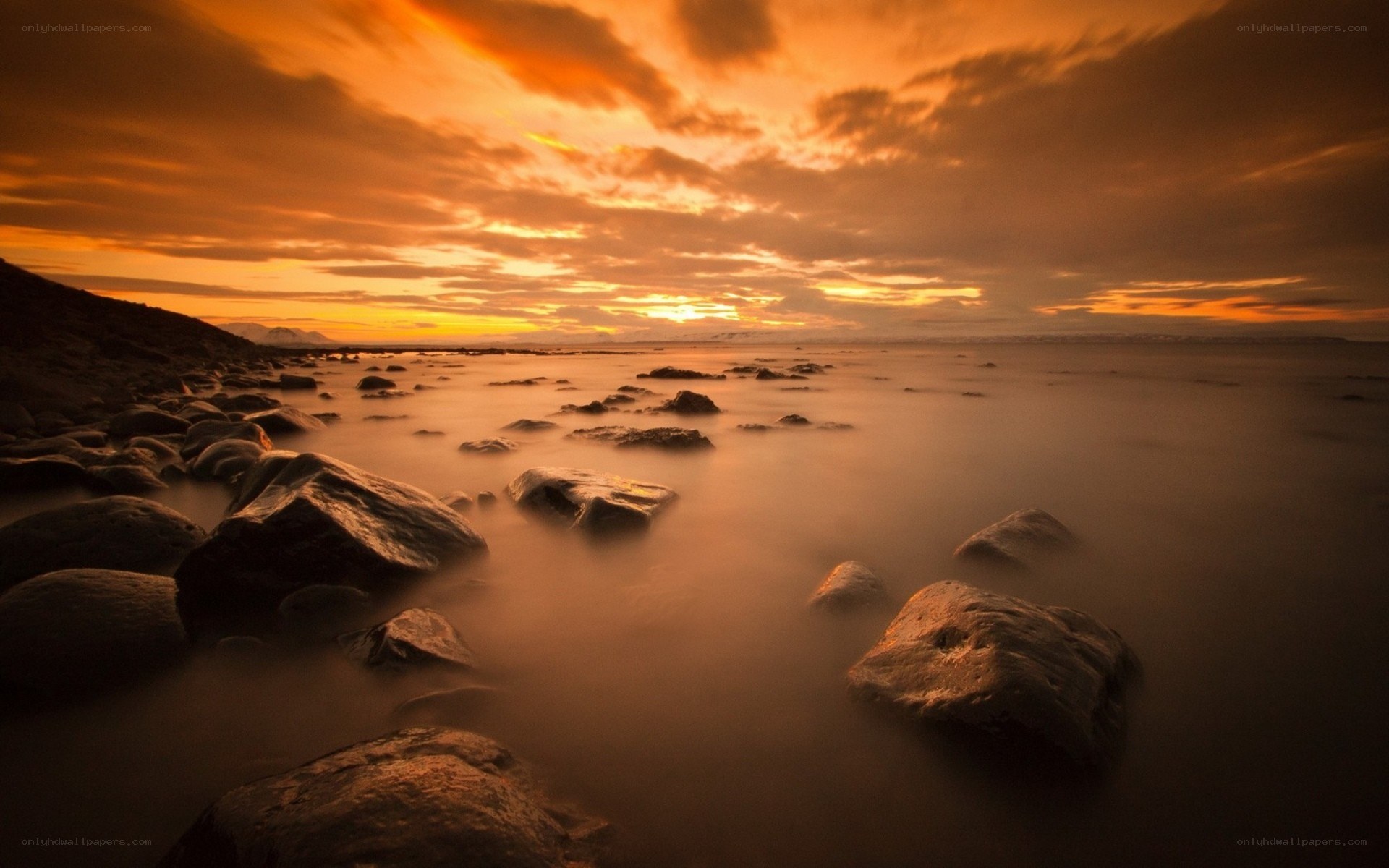 Sunset over rocky shore