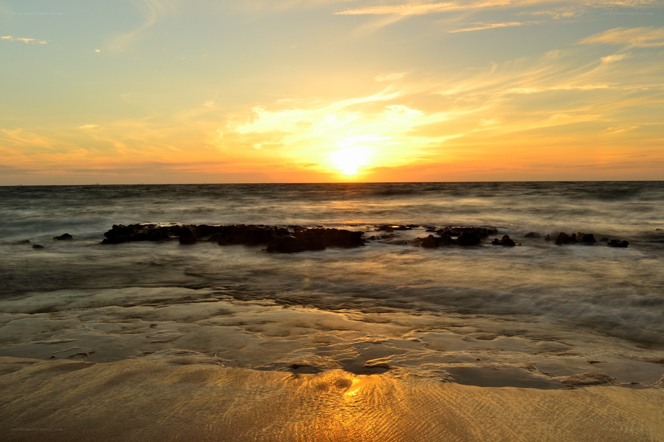 Sunset over rocky shore