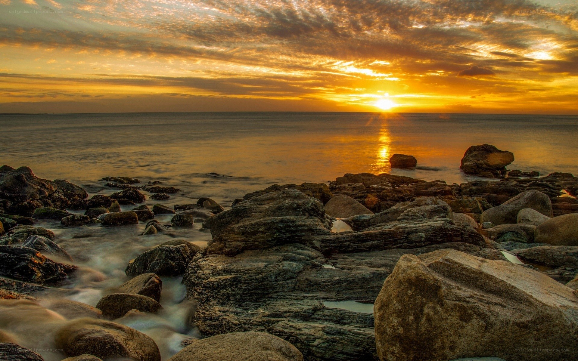 Sunset over rocky shore
