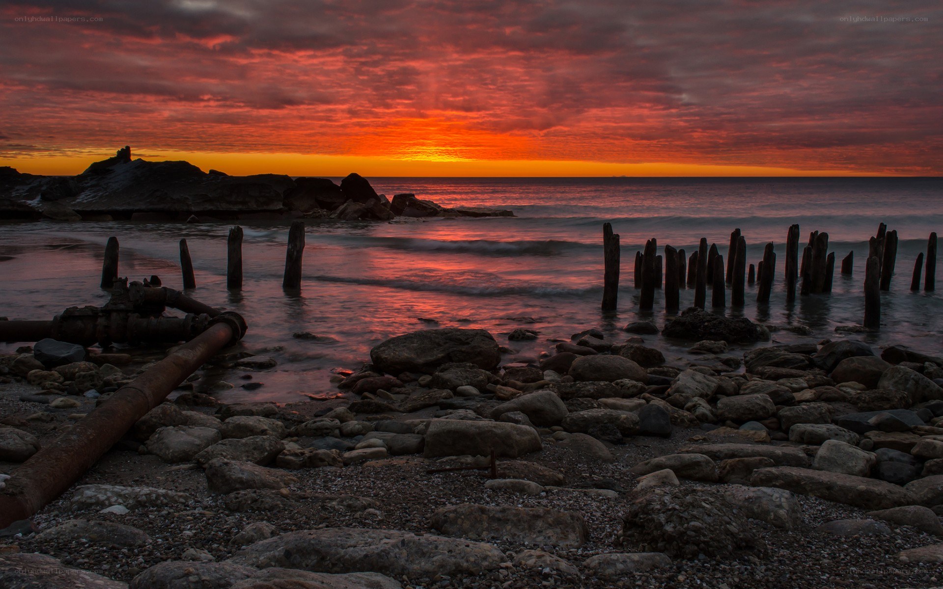 sunset over rocky shore