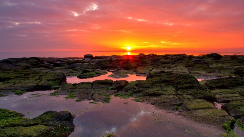 sunset over rocky shore