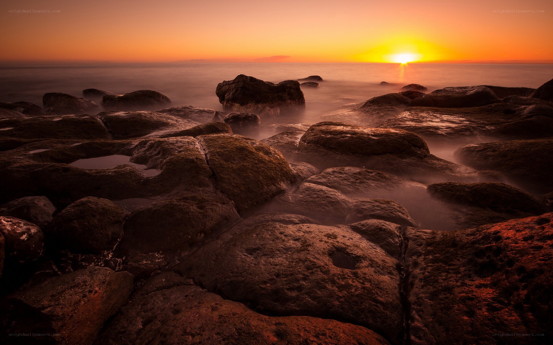 Sunset over rocky shore