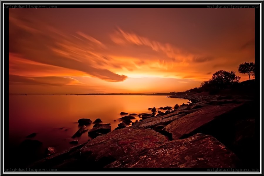 Sunset over rocky shore