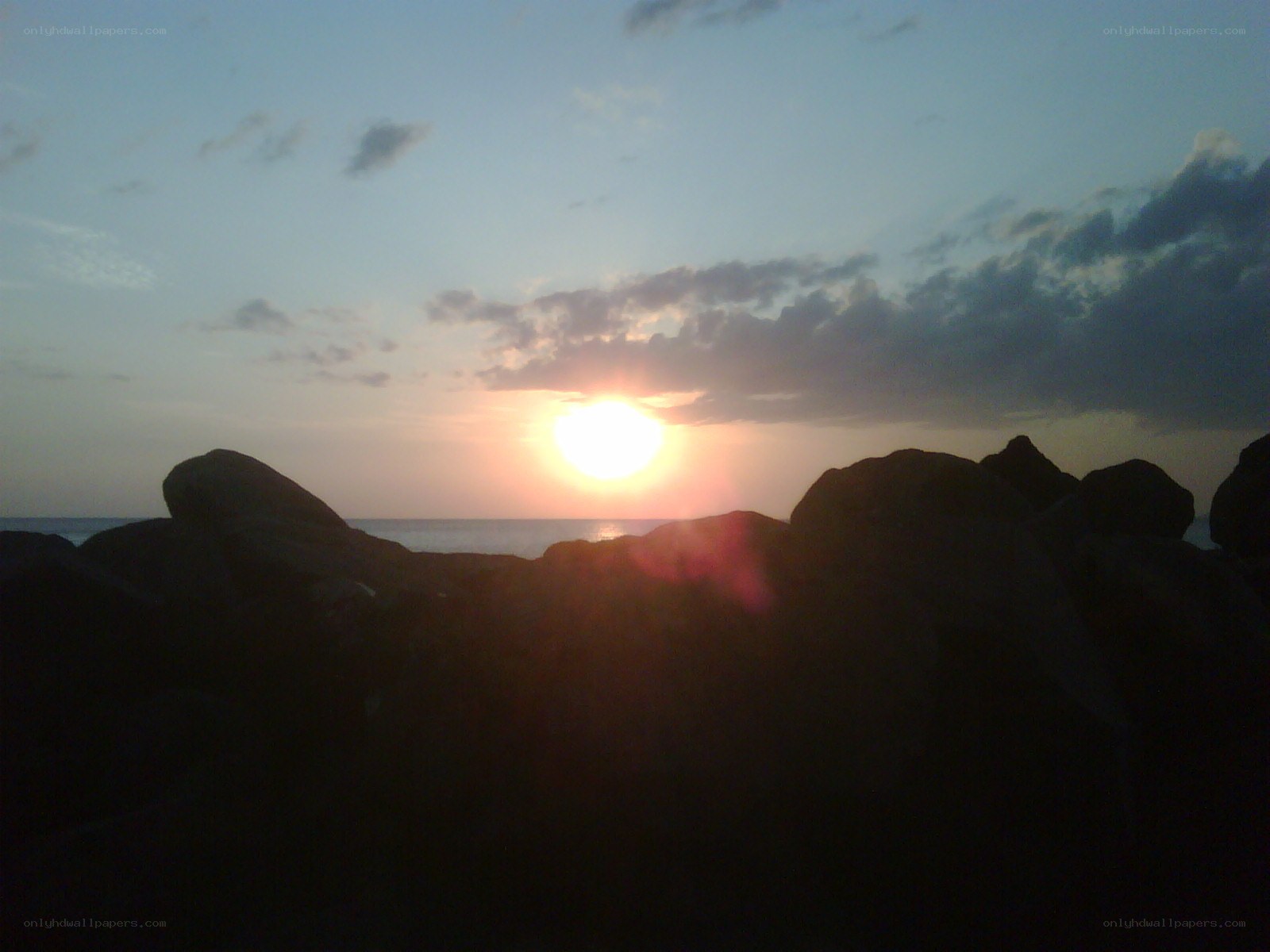 Sunset over rocky shore